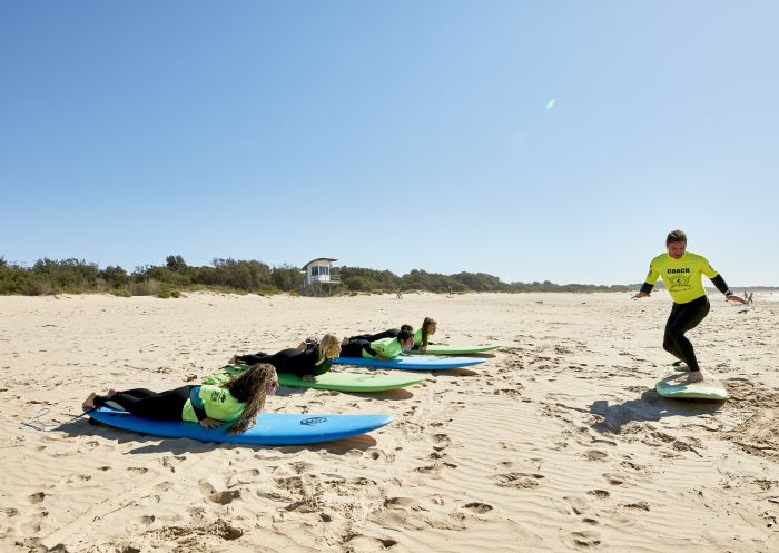 Illawarra Surf Academy, Wollongong Women learning how to surf with Illawarra Surf Academy on Corrimal Beach near Wollongong
