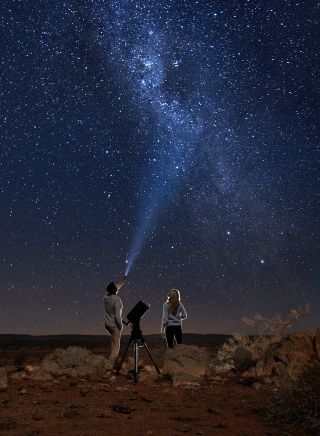 Couple star gazing beneath the Milky Way, Outback Astronomy, Broken Hill